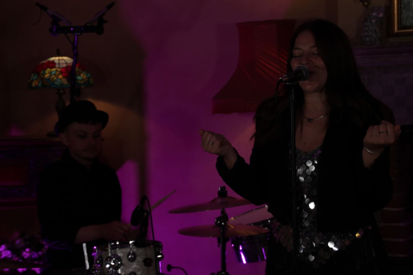 Anna performing with her band under stage lighting